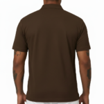 Man wearing a dark brown polo t-shirt with a small white V logo on the left chest holding a coffee cup.