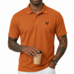 Man wearing a dark brown polo t-shirt with a small white V logo on the left chest holding a coffee cup.