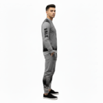 Full-body studio mockup of a man wearing a VALE brand breathable cotton tracksuit featuring a hand-passing-a-key graphic and ink-splatter design, available in grey, brown, and white-black contrast.