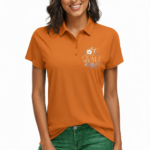 Close-up of a woman wearing a breathable pique cotton polo shirt featuring a "VALE" floral and crescent moon embroidery on the chest, available in green, blue, and orange.