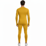 Front view of a man wearing VALE brand 2-piece compression suits in multiple colors including white, navy, orange, and yellow, featuring signature gold side-logos and central compass graphics on breathable cotton-blend fabric.