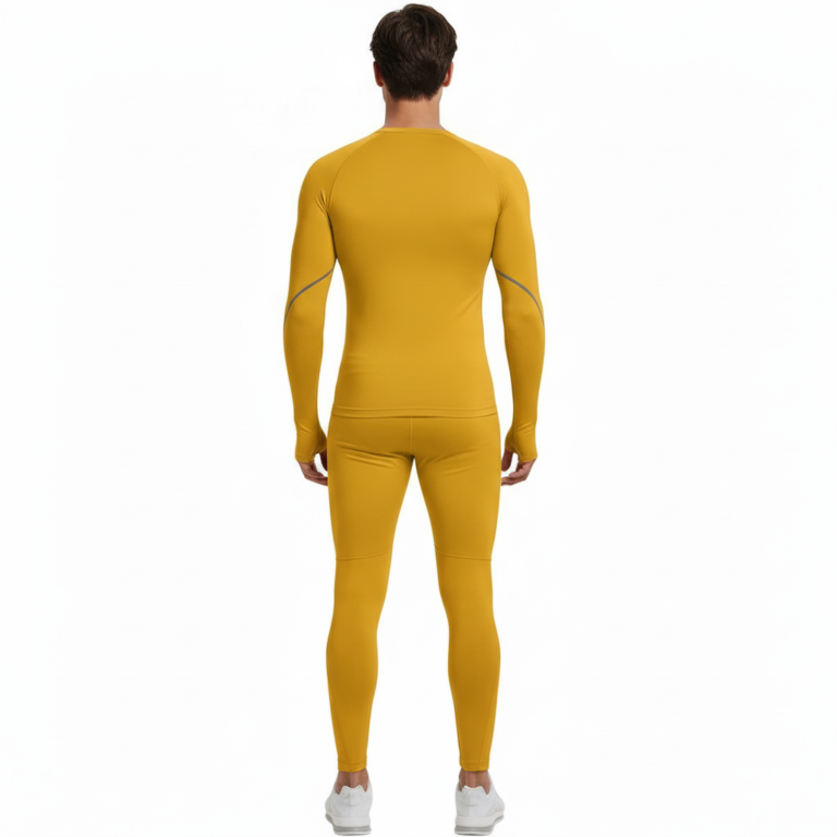 Front view of a man wearing VALE brand 2-piece compression suits in multiple colors including white, navy, orange, and yellow, featuring signature gold side-logos and central compass graphics on breathable cotton-blend fabric.