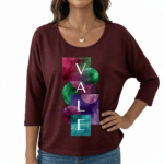 Front view of a woman wearing a breathable cotton 3/4 sleeve shirt with a "VALE" artistic watercolor geometric graphic design, available in maroon, black, and blue.