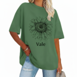 Front view of a woman wearing a Vale brand oversized cotton t-shirt featuring a large black line-art sunflower graphic, available in beige, blue, and green.