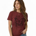 Woman wearing a Vale brand butterfly graphic t-shirt in brown, white, and maroon, featuring a vintage botanical butterfly design on 100% breathable cotton fabric.