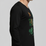 A man wearing a long-sleeve cotton shirt with a "VALE" nature graphic featuring a mountain, eagle, and tree, available in cream, black, and chocolate brown.