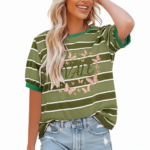 A smiling model wearing a breathable VALE brand cotton t-shirt with horizontal stripes, featuring a central butterfly graphic design and puff sleeves, paired with light-wash distressed denim jeans against a clean white background.