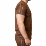 Full-body view of a man wearing the VALE brand breathable cotton activewear set, featuring a vertical logo t-shirt and matching side-striped joggers on a white background.