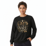 Person wearing a VALE graphic cotton sweatshirt featuring botanical leaves, acorns, and stars in Black, Forest Green, and Burnt Orange colors.