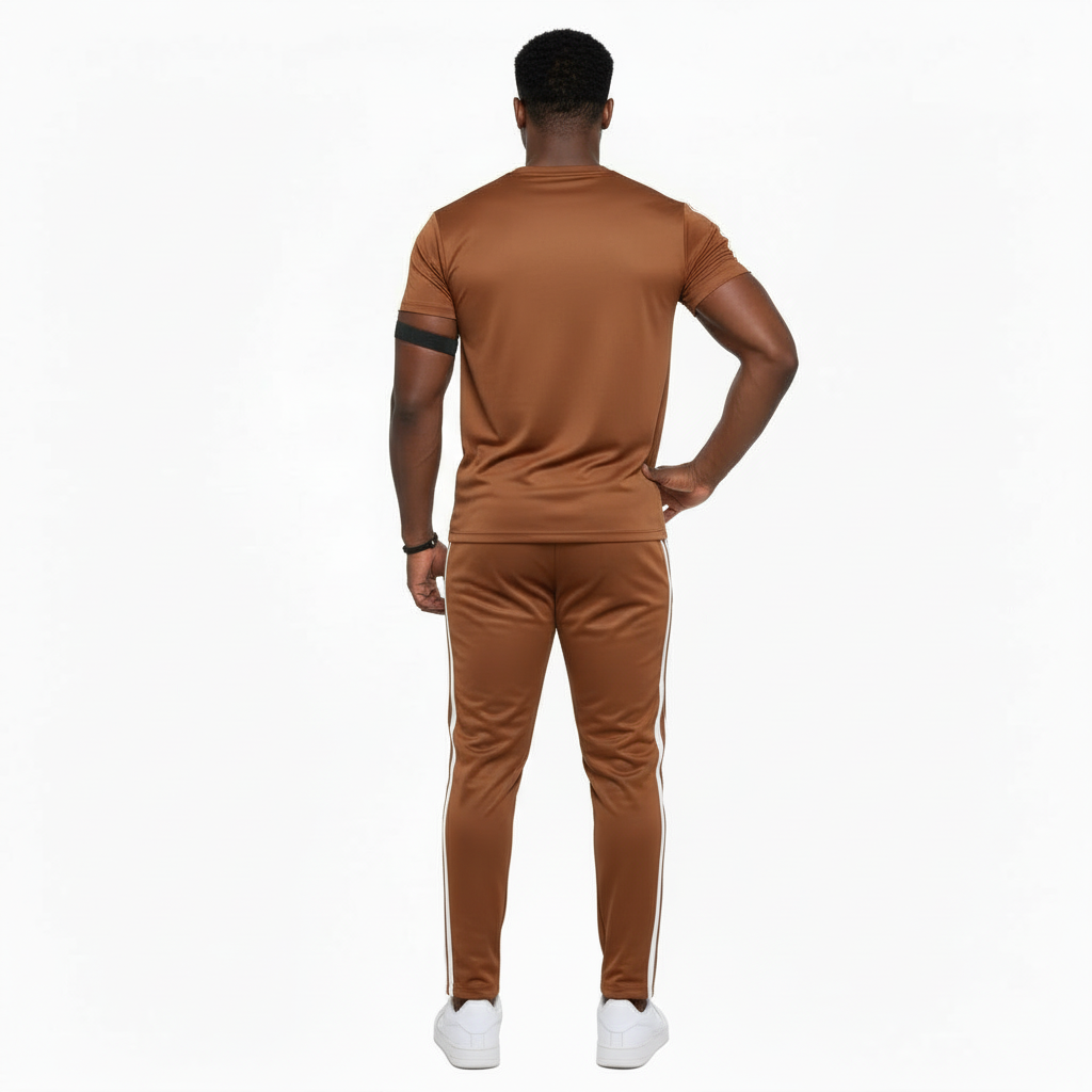 Man wearing VALE brand breathable cotton tracksuit with short-sleeve t-shirt and matching joggers in earth tones.