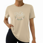 Woman wearing a "Vale" brand floral graphic t-shirt in breathable cotton, available in Forest Green, Olive, and Sand Beige colors.