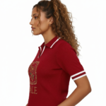 A high-quality studio shot of a model wearing a VALE brand breathable cotton polo shirt featuring white-tipped collars and a detailed gold floral celestial embroidery on the chest.