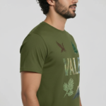 Man wearing a VALE nature graphic t-shirt featuring an eagle, pine tree, and mountain design in 100% breathable cotton.