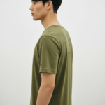 Back view of a man wearing a Terracotta VALE slim-fit t-shirt with a vertical black logo on the spine