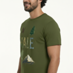 Man wearing a VALE nature graphic t-shirt featuring an eagle, pine tree, and mountain design in 100% breathable cotton.