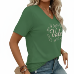 A woman wearing a breathable cotton V-neck T-shirt with a "Vale" butterfly graphic design, available in brown, green, and grey.