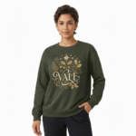 Person wearing a VALE graphic cotton sweatshirt featuring botanical leaves, acorns, and stars in Black, Forest Green, and Burnt Orange colors.