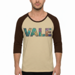 Men's VALE patchwork raglan shirt in white, grey, and cream with black and brown 3/4 sleeves, featuring decorative textured lettering.
