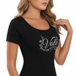 Close-up of a woman wearing a breathable ribbed cotton t-shirt featuring a glittery "Vale" graphic design with floral accents.