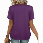 Close-up of a woman wearing a breathable cotton V-neck t-shirt featuring a gold floral "VALE" graphic and a small chest pocket, paired with blue jeans.