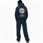 Men's 2-piece breathable cotton performance tracksuit featuring a quarter-zip long-sleeve shirt and joggers with contrast side panels and gold VALE compass logo, available in Black, White, Blue, and Red.