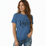 Woman wearing a "Vale" script graphic t-shirt made of breathable cotton, paired with distressed denim jeans, available in Slate Blue, Heather Grey, and Mint Green.