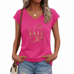 Professional studio shot of a woman wearing a VALE brand V-neck breathable cotton t-shirt with a metallic gold cursive logo, styled with denim jeans and gold accessories.