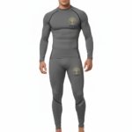 Front view of a man wearing a VALE brand 2-piece compression suit featuring a gold Tree of Life mandala graphic on the long-sleeve top and matching leggings, shown in brown, olive green, and grey colors.