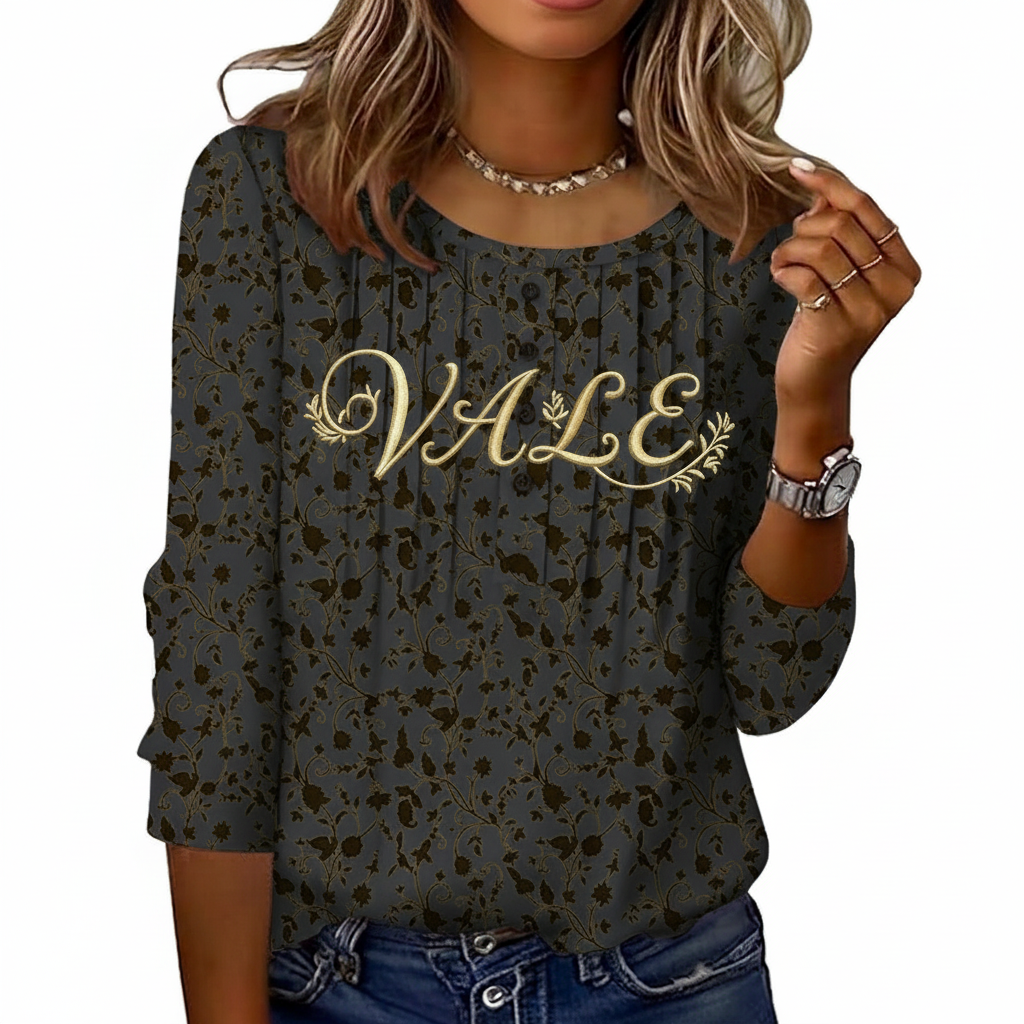 Women's breathable floral cotton blouse with VALE gold embroidery and pleated button-front design.