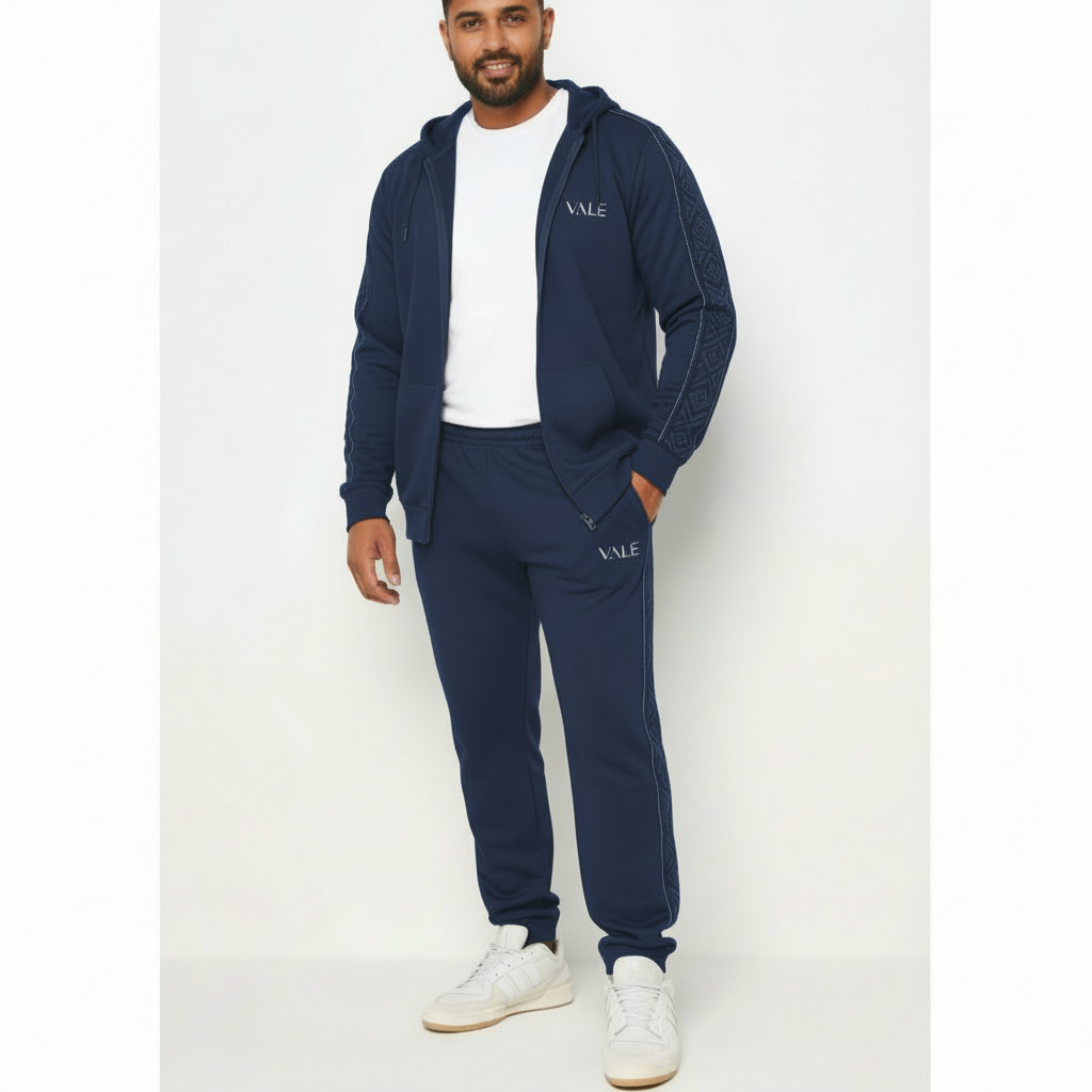 Men's premium cotton zip-up tracksuit featuring a hooded sweatshirt and matching joggers with geometric side-stripe detailing and VALE logo.