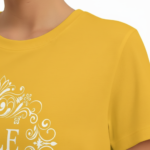 Women wearing VALE brand cotton graphic t-shirt with white filigree mandala design, available in blue, mustard, and cream.