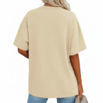 Front view of a woman wearing a Vale brand oversized cotton t-shirt featuring a large black line-art sunflower graphic, available in beige, blue, and green.