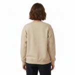 Woman wearing a VALE graphic cotton sweatshirt with autumn leaf botanical design, available in Beige, Slate Blue, and Burnt Orange.