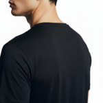 Close-up of a man wearing a burnt orange VALE distressed graphic t-shirt with white block lettering.