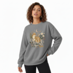 "Professional studio shot of a woman wearing a VALE brand cotton sweatshirt featuring a detailed fox and moon graphic design, available in Maroon, Forest Green, and Heather Gray."