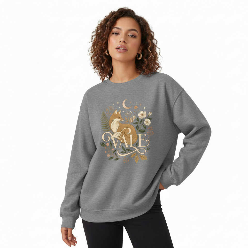 VALE Celestial Fox Oversized Cotton Sweatshirt "Professional studio shot of a woman wearing a VALE brand cotton sweatshirt featuring a detailed fox and moon graphic design, available in Maroon, Forest Green, and Heather Gray."
