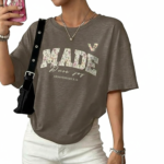 Flat lay and model view of women's oversized "MADE Pure Joy" floral graphic t-shirt in dusty brown, slate blue, and sage green.