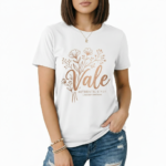 Female model wearing a Vale Limited Edition floral graphic t-shirt made of breathable cotton, featuring copper metallic flower design and script lettering.
