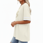 Woman wearing VALE graphic cotton t-shirt with striped sleeves and laurel wreath design in Blue, Plum, and Cream colors.