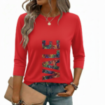 A woman wearing a breathable 3/4 sleeve cotton t-shirt with a colorful vertical "VALE" graphic print, available in cream, red, and black