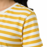 Young woman wearing a VALE brand horizontal striped breathable cotton t-shirt in blue, yellow, and green colors.