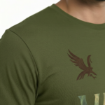 Man wearing a VALE nature graphic t-shirt featuring an eagle, pine tree, and mountain design in 100% breathable cotton.