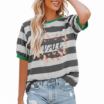 A smiling model wearing a breathable VALE brand cotton t-shirt with horizontal stripes, featuring a central butterfly graphic design and puff sleeves, paired with light-wash distressed denim jeans against a clean white background.