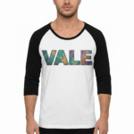 Men's VALE patchwork raglan shirt in white, grey, and cream with black and brown 3/4 sleeves, featuring decorative textured lettering.