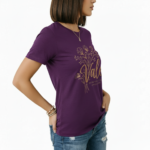 Female model wearing a Vale Limited Edition floral graphic t-shirt made of breathable cotton, featuring copper metallic flower design and script lettering.
