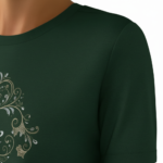 A woman wearing a premium breathable cotton t-shirt featuring the "Vale" brand logo in white script surrounded by a floral wreath with pink roses. Available in forest green, mustard orange, and cream beige colors.