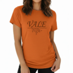 Woman wearing a VALE brand graphic t-shirt in breathable cotton, featuring a minimalist leaf design and athletic slim fit. Available in Black, Purple, and Orange.