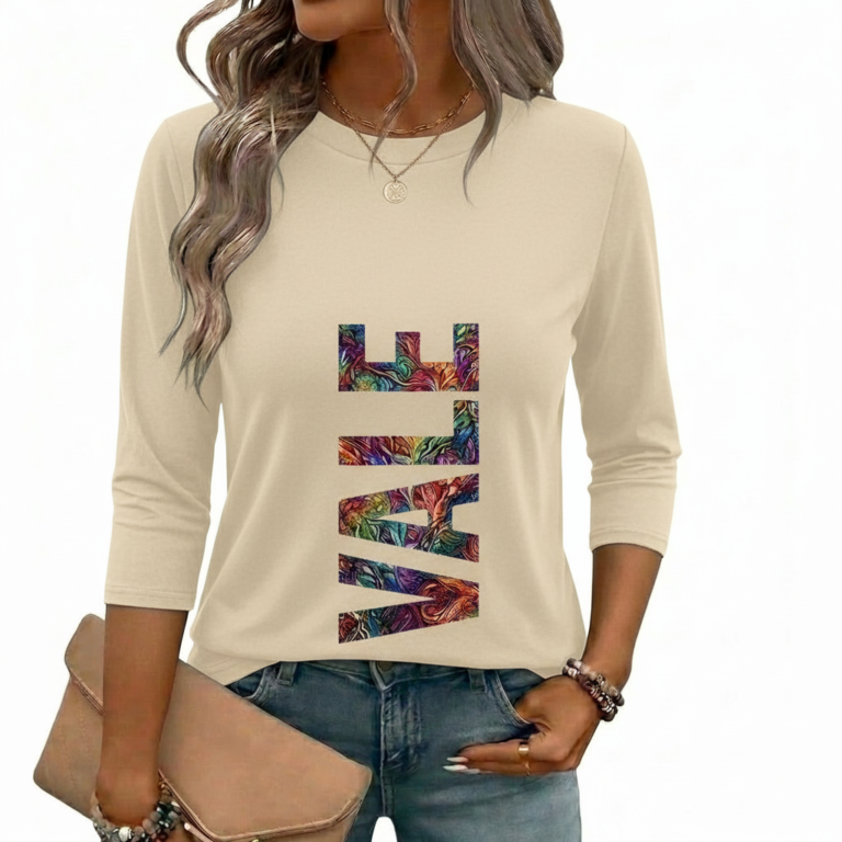 A woman wearing a breathable 3/4 sleeve cotton t-shirt with a colorful vertical "VALE" graphic print, available in cream, red, and black