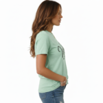 Woman wearing a "Vale" script graphic t-shirt made of breathable cotton, paired with distressed denim jeans, available in Slate Blue, Heather Grey, and Mint Green.
