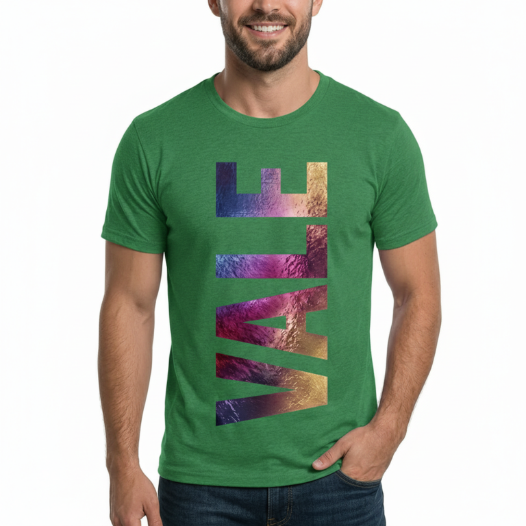 A man wearing a slim-fit 100% cotton t-shirt with a vertical 'VALE' graphic in a vibrant purple, gold, and blue metallic texture.